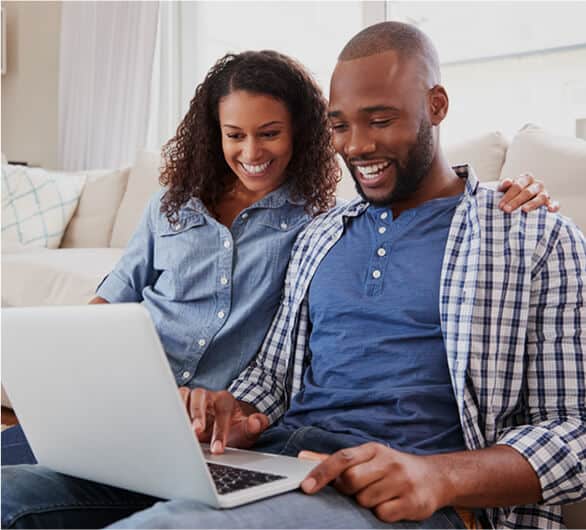 couple-smiles-at-laptop couple smiles at laptop