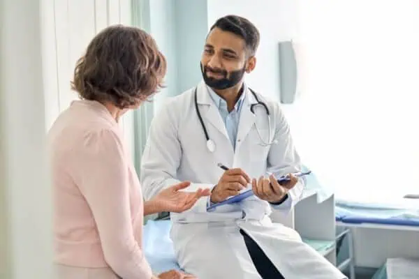 A female doctor sharing blood test results with a male patient
